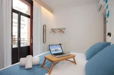 a bedroom with a laptop sitting on a bed at Casual Socarrat Valencia - Adults Only in Valencia