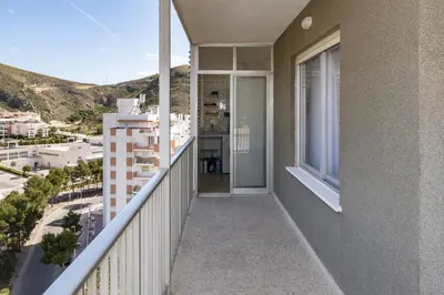 a balcony with a view of a city at AGUAMARINA C, 11-51 in Cullera