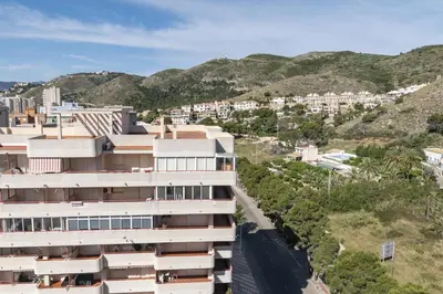 an aerial view of a building with mountains in the background at AGUAMARINA C, 11-51 in Cullera