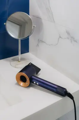 a mirror sitting on a counter next to a flashlight at Room Mate Collection Helen Berger in Valencia
