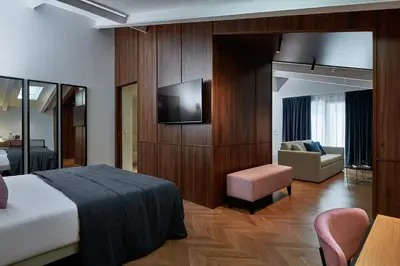 a hotel room with a bed and a television at Room Mate Collection Helen Berger in Valencia
