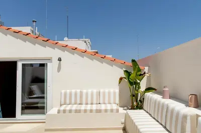 a white house with white furniture on a patio at Room Mate Collection Helen Berger in Valencia