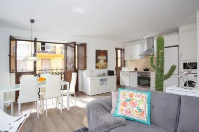 a living room and kitchen with a couch and a table at SingularStays Valencia Center in Valencia