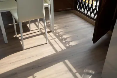 a shadow of a table and chair on a wooden floor at SingularStays Valencia Center in Valencia