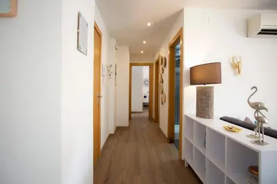 a hallway of a house with white walls and wooden floors at SingularStays Valencia Center in Valencia