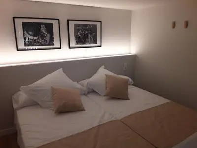 a bed with three pillows on it in a room at SLEEP TURIA LLIRIA in Lliria