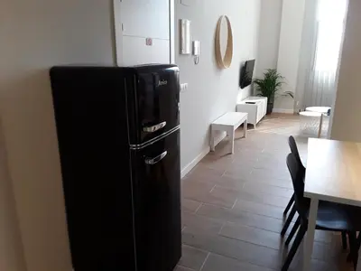 a black refrigerator in a room with a table at SLEEP TURIA LLIRIA in Lliria