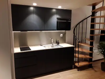 a kitchen with a sink and a staircase at SLEEP TURIA LLIRIA in Lliria