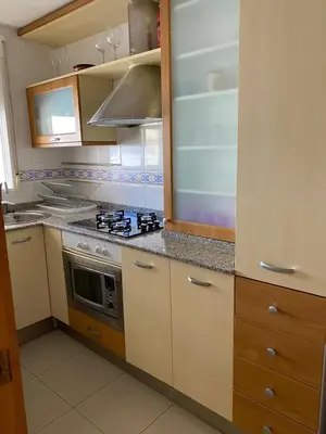 a kitchen with a stove and a microwave at Moncofa Beach in Moncófar