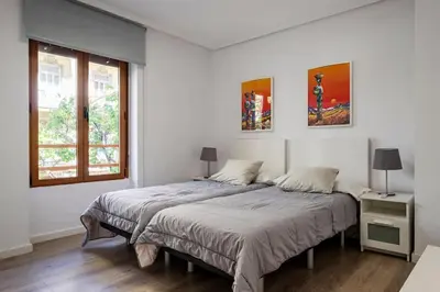 a bedroom with two beds and a window at Garden Turia Downtown in Valencia