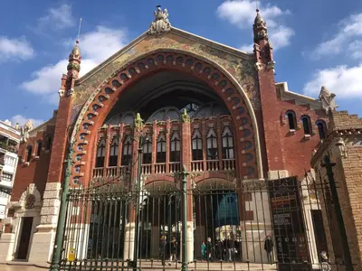 a large brick building with a gate in front at Garden Turia Downtown in Valencia