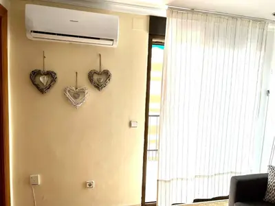 two hearts hanging on a wall next to a window at Moderno y acogedor apartamento para 6 personas in Valencia