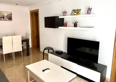 a living room with a flat screen tv on a wall at Moderno y acogedor apartamento para 6 personas in Valencia
