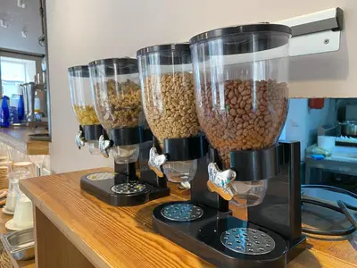a counter with three food processors filled with food at YOU & CO. Quart Boutique in Valencia