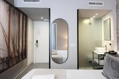 a bathroom with a mirror and a sink at YOU & CO. Quart Boutique in Valencia