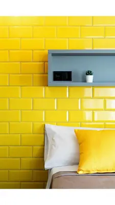 a yellow brick wall behind a bed with yellow pillows at Nest Style Valencia in Valencia