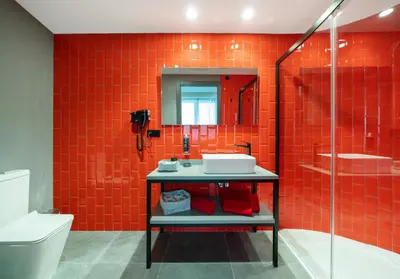 a red bathroom with a sink and a shower at Nest Style Valencia in Valencia