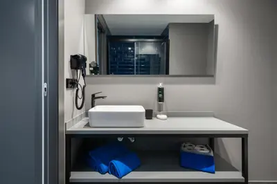 a bathroom with a white sink and a mirror at Nest Style Valencia in Valencia