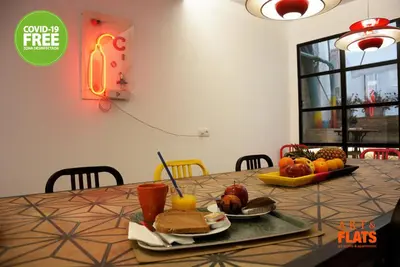 a table with a plate of food and fruit on it at Art&Flats Hostel in Valencia