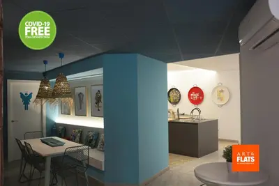 a room with a table and a dining room with clocks at Art&Flats Hostel in Valencia