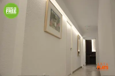 a hallway with paintings on the walls of a building at Art&Flats Hostel in Valencia