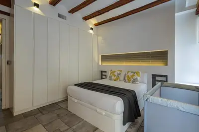 a bedroom with a bed in a room with white cabinets at FLORIT FLATS - CENTER MODERN 1BR 2Bth TERRACE WI-FI AC in Valencia