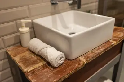 a white sink on a wooden counter in a bathroom at FLORIT FLATS - CENTER MODERN 1BR 2Bth TERRACE WI-FI AC in Valencia