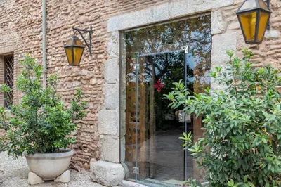 an entrance to a brick building with a glass door at Alquería Calatrava B&B in Burriana