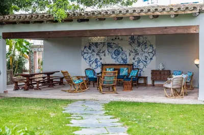 a patio with a bunch of chairs and tables at Alquería Calatrava B&B in Burriana
