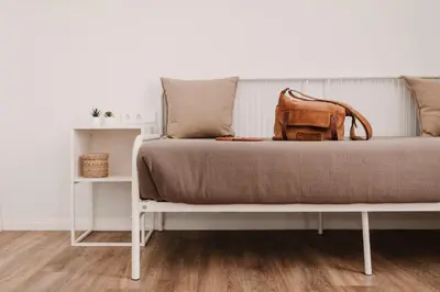 a bed with a brown bag sitting on it at Lindala in Valencia