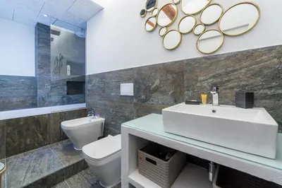 a bathroom with a sink and a toilet and mirrors at FLORIT FLATS - CATHEDRAL LUXURY TERRACE FLAT 2BR 2BA AC Wifi in Valencia