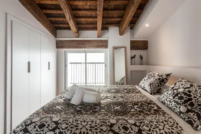 a bedroom with a large bed with pillows at FLORIT FLATS - CENTER 2BR 2BA ATTIC TERRACE VIEW WIFi AC in Valencia