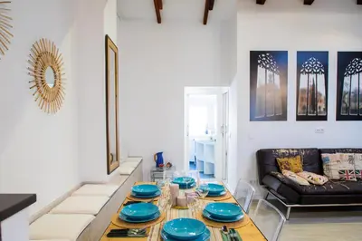 a living room with a table with blue plates on it at FLORIT FLATS - Cabanyal 3 Bedroom WIFI AC Terrace Beach Penthouse in Valencia