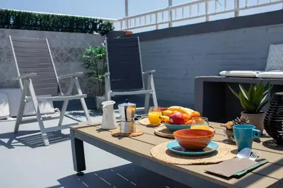 a table with a tray of fruit on a patio at FLORIT FLATS - Cabanyal 3 Bedroom WIFI AC Terrace Beach Penthouse in Valencia