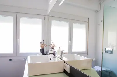 a bathroom with two sinks and two windows at FLORIT FLATS - Cabanyal 3 Bedroom WIFI AC Terrace Beach Penthouse in Valencia
