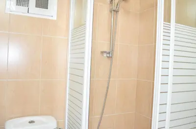 a bathroom with a shower and a toilet at VIRGEN APARTAMENT HOTEL in Cullera