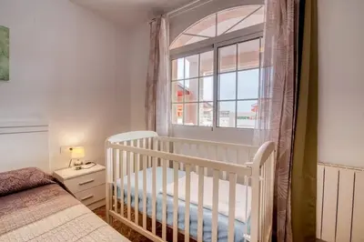 a white crib in a bedroom with a window at Family Villa in Benifayó with Year-Round Private Pool in Benifayó