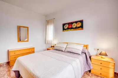 a bedroom with a bed and two dressers and a mirror at Family Villa in Benifayó with Year-Round Private Pool in Benifayó