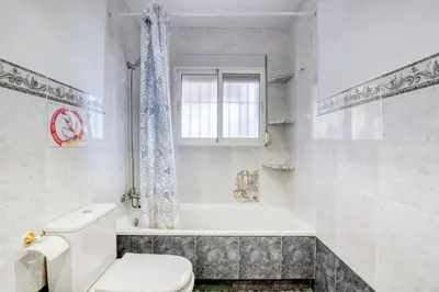 a white bathroom with a toilet and a bath tub at Family Villa in Benifayó with Year-Round Private Pool in Benifayó