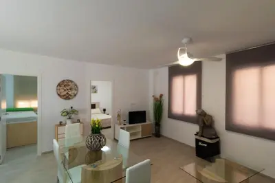 a living room with a table and a dining room at Bioparc Metro Valencia in Valencia