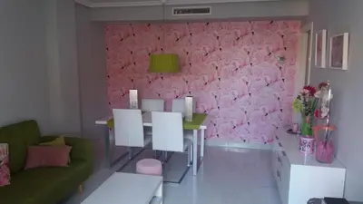 a living room with a pink wall at Apartamento playa canet d'en Berenguer in Canet de Berenguer