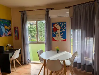 a dining room with a table and chairs and a window at Apartamento zona residencial Montesol in La Eliana