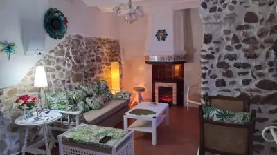 a living room with a couch and a fireplace at Rosita Casa Rural in Estivella