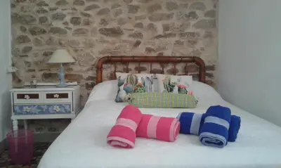 a bedroom with a bed with pillows on it at Rosita Casa Rural in Estivella