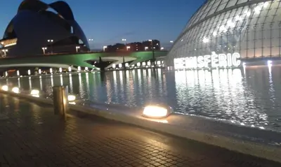 a large building with lights in the water at night at Rosita Casa Rural in Estivella