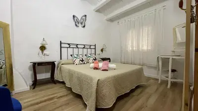 a bedroom with a bed with pink pillows on it at Rosita Casa Rural in Estivella