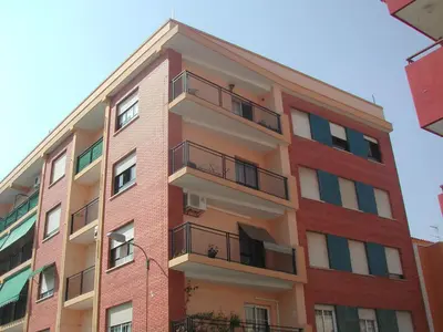 a tall brick building with balconies on it at Vacaciones en Valencia in Burjasot