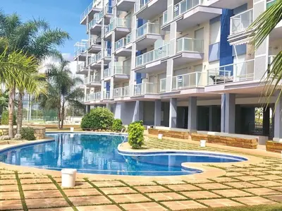 a swimming pool in front of a building at The Apartment Olivia in Moncófar