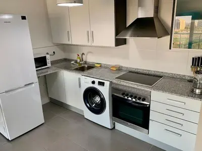 a kitchen with a washing machine and a sink at The Apartment Olivia in Moncófar