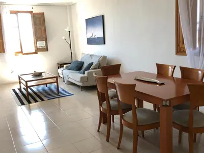 a living room with a table and chairs and a couch at Apartamento Puerto de Sagunto Playa in Puerto de Sagunto